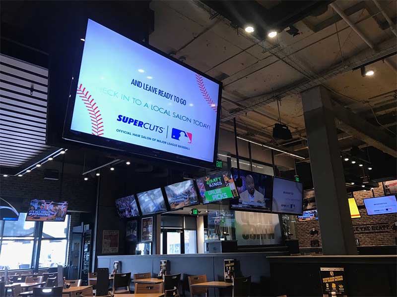 Buffalo Wild Wings, Supercuts and REACH have partnered together to create a digital signage experience